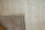 Distressed Tulu rug's tightly woven foundation and light beige pile.