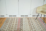 Distressed modern abstract Oushak rug with colorful diamond and circular patterns.