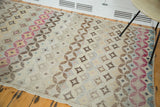 Modern distressed Oushak rug with abstract diamond-circle pattern in cranberry, gold, and blue.