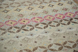 Distressed modern abstract Oushak texture featuring diamond and circular motifs.