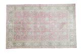 Distressed vintage Turkish Oushak rug, faded cranberry floral field, grey-green abstract border, 6' x 9'4