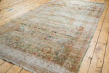 Distressed Sivas carpet with allover lattice, floral motifs, and faded teal-rust abrash.