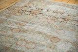 Distressed Sivas carpet with faded teal, rust floral motifs and prominent abrashes.