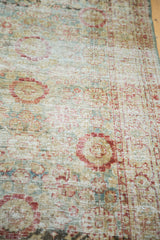 Distressed vintage Sivas rug with muted rust, gold, teal floral motifs and abrashes.