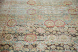 Distressed Sivas carpet showcasing abrashes and faded floral motifs in teal, gold, rust.