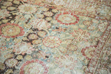 Distressed Sivas carpet texture showing abrashes, floral lattice motifs, and tones of rust, gold, teal.