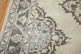 Oushak runner's distressed lattice medallion and floral border in ivory, charcoal, and slate blue.