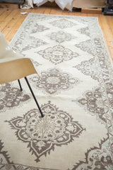 Distressed Oushak runner with faded ivory and charcoal lattice medallion.