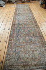 Worn texture of vintage Malayer runner, showing herati pattern in muted greens and cinnabar red.