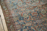 Distressed Malayer rug texture featuring emerald green and worn cinnabar red herati pattern.
