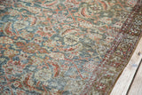 Distressed emerald green Malayer runner showing worn herati pattern with red and gold tones.