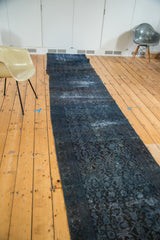 Distressed vintage overdyed runner, showing dark blue Herati motif and patterned border.