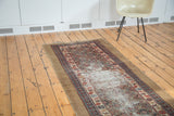 Antique Caucasian runner rug, gold and red hues, repeating medallions, localized pile wear.