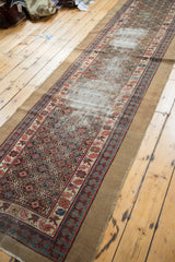 Detailed view of antique Caucasian runner's distressed field and Lehla-Abassi border.