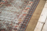 Distressed texture of an antique Caucasian runner with madder red, teal geometric patterns, Lehla-Abassi border.