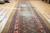 Antique Caucasian runner with distressed geometric medallions and madder red, teal Lehla-Abassi border.