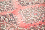 Close-up of distressed Oushak runner's geometric tribal motifs in faded cinnabar and charcoal.