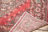 Distressed tribal red Oushak runner pile texture and hand-knotted reverse construction.