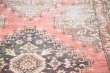 Distressed texture of a vintage Oushak runner with faded cinnabar and charcoal tribal motifs.