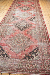 Distressed Oushak runner showcasing faded cinnabar, cherry red, and brown geometric staggered medallions. 5'2