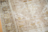 Distressed texture showcasing geometric floral border of the Oushak rug.