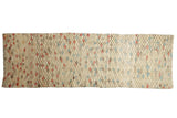 Decorative distressed Oushak runner featuring an ivory field with unique colorful diamond patterns.
