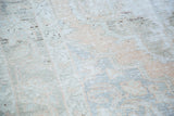 Distressed Oushak pile texture with tone-on-tone peach, ivory, and soft silver abrashes.
