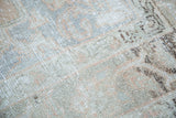 Distressed pile of vintage Oushak carpet with muted peach, silver, and gray abrashes.