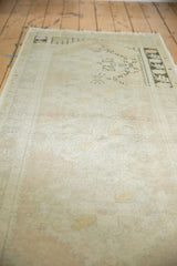 Textural detail of distressed Oushak runner, with soft ivory and faded apricot peach hues.