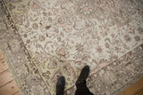 Textural detail of a distressed Oushak carpet with pale rose and green accents.
