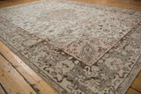 Distressed rose corner spandrel and cloudband border on vintage Oushak rug.