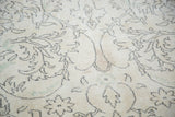 Vintage Oushak rug pattern featuring distressed ivory, faded green, and charcoal florals.