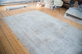 Hand-knotted vintage Oushak carpet detail, muted beige field and floral motifs.