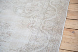 Hand-knotted Oushak carpet border in soft beige, ivory, with pastel pink accents.