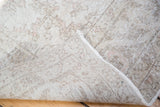 Oushak rug corner showing its hand-knotted construction and subtle pastel tones.