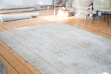 Subtle beige and ivory floral field pattern on the vintage hand knotted Oushak rug.
