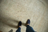 Faded celadon, bronze floral vines on a hand knotted vintage Oushak rug's field.