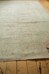 Hand-knotted Oushak rug fringe and border with faded celadon green floral vines.