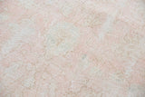 Distressed character of Oushak rug with blush rose, ivory, and blanched light grey.