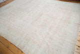 Distressed blush rose, ivory, and light grey field with subtle faded floral patterns.