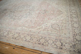 Distressed Turkish Oushak carpet detail: faded blush, sea foam, charcoal floral patterns.