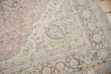 Traditional Oushak carpet: distressed floral pattern in faded blush, sea foam, charcoal, ivory.