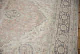 Distressed Turkish Oushak rug pile with faded blush, sea foam green, charcoal floral motifs.