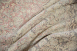 Distressed Oushak carpet texture with faded blush, sea foam green, charcoal, and ivory tones.