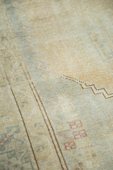 Distressed hand knotted Oushak pile with muted beige, sea foam, and coffee-toned zigzag patterns.