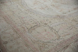 Distressed Oushak carpet, featuring soft blush rose and ivory tones in formal motifs.