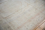 Distressed Oushak carpet pile showing faded antique ivory, blush, and soft blue patterns.
