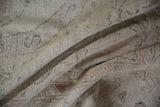Faded formal patterns and textural distressed pile in ivory, blush, and soft blue.