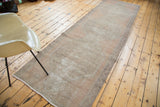 Distressed hand-knotted Oushak runner showing soft beige and apricot muted tones.