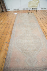 Distressed Oushak runner texture in soft apricot and beige with a subtle diamond medallion.